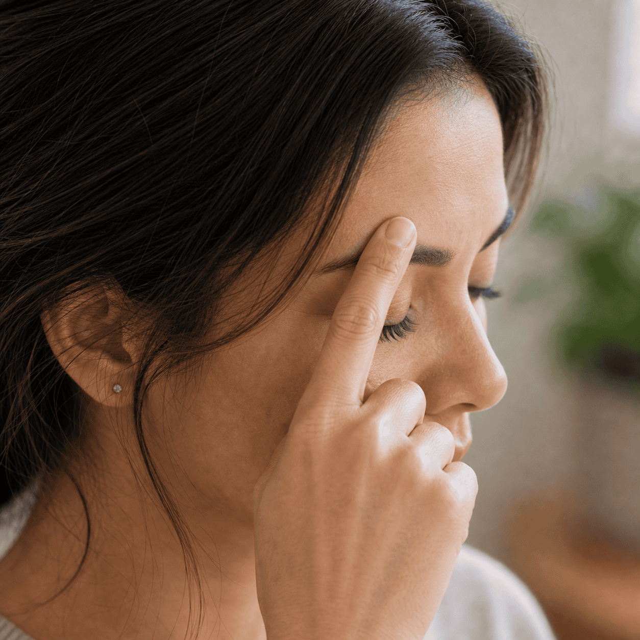 Gentle self-acupressure for the GB-14 area Self-care acupressure around the forehead area above the middle of the eyebrow